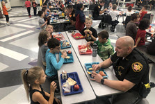 police officers eating lunch with students in cafeteria